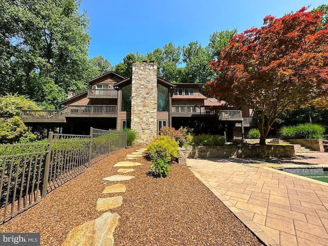 exterior space featuring a deck and fence