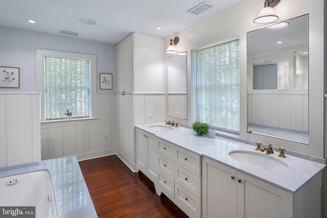 bathroom with vanity, a bathtub, and hardwood / wood-style flooring