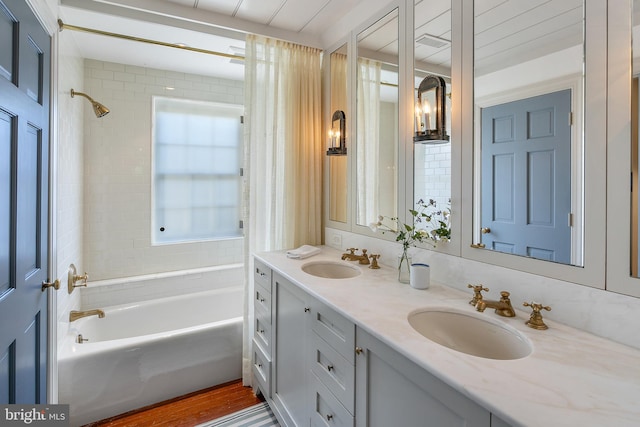 bathroom featuring vanity, tiled shower / bath, and wood-type flooring