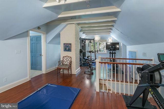 workout area with wood-type flooring and vaulted ceiling