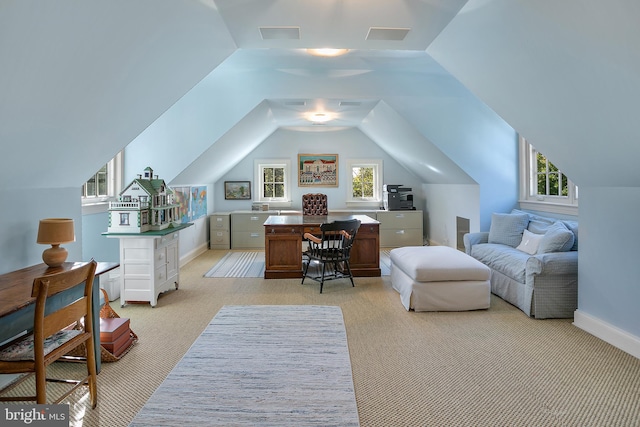 carpeted office space featuring vaulted ceiling