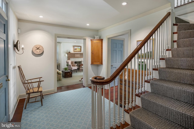 staircase with hardwood / wood-style floors