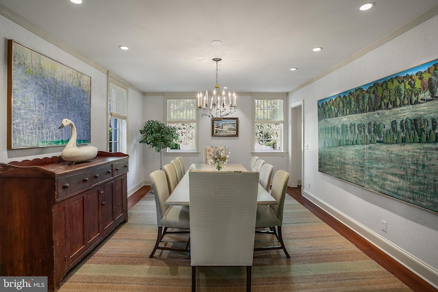 dining area featuring ornamental molding, dark wood-type flooring, and a notable chandelier