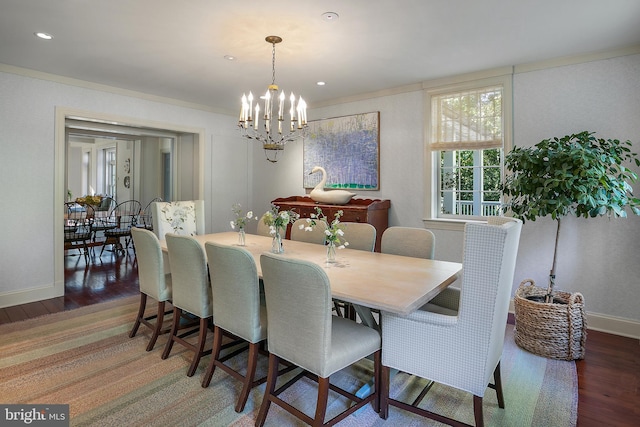 dining area with dark hardwood / wood-style floors and a chandelier