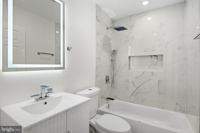 full bathroom featuring toilet, vanity, and tiled shower / bath