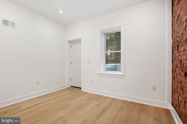 spare room featuring light wood-type flooring