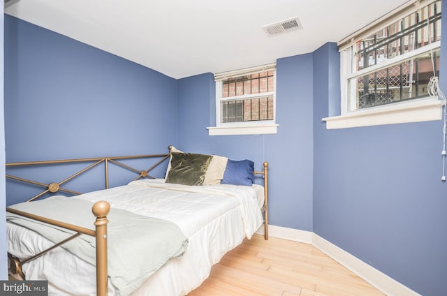 bedroom with hardwood / wood-style flooring