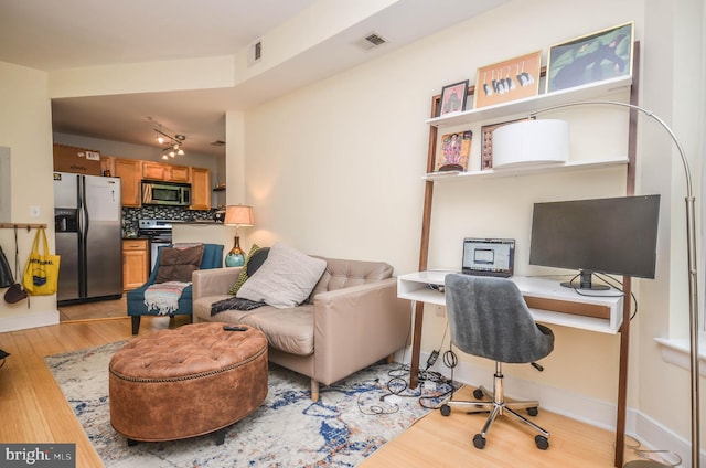 office with light hardwood / wood-style flooring