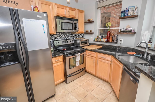 kitchen featuring light tile patterned flooring, sink, tasteful backsplash, dark stone countertops, and stainless steel appliances