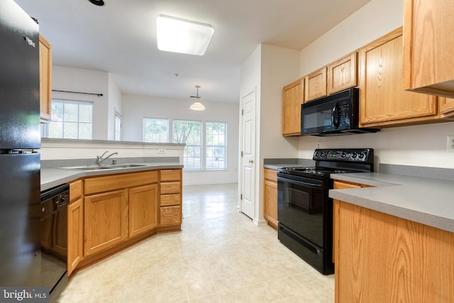 kitchen with sink, black appliances, pendant lighting, kitchen peninsula, and light tile patterned flooring