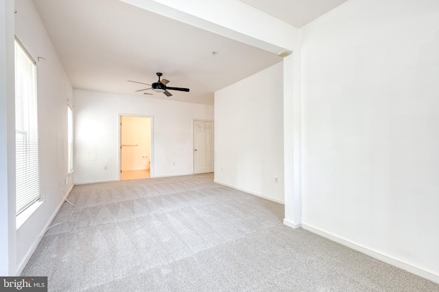 carpeted spare room featuring ceiling fan