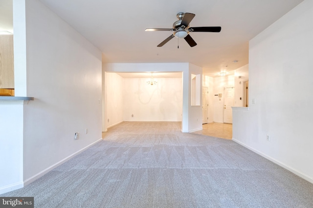 unfurnished living room featuring light colored carpet and ceiling fan