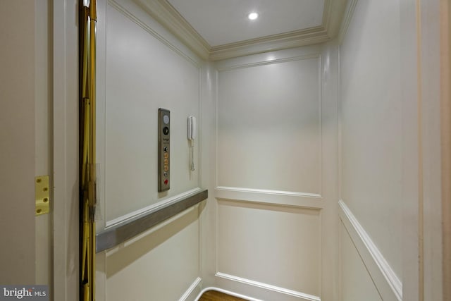 interior details with crown molding, recessed lighting, and elevator