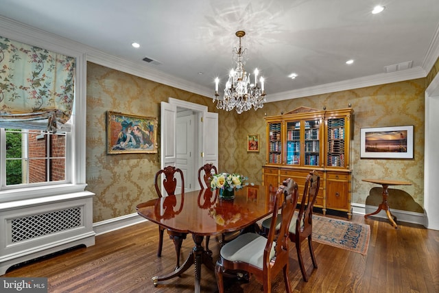 dining room with dark wood-style floors, crown molding, visible vents, and wallpapered walls