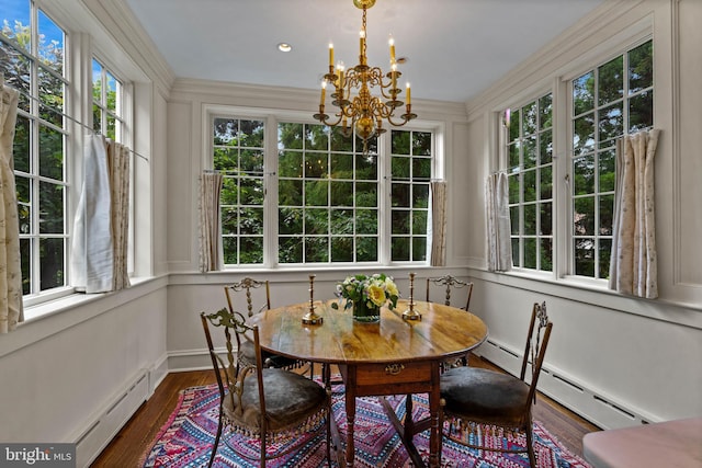 sunroom / solarium with a baseboard radiator, baseboard heating, and an inviting chandelier