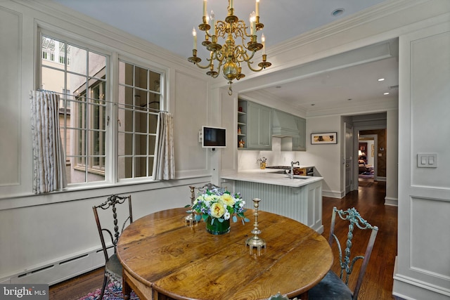 dining area featuring baseboards, dark wood finished floors, crown molding, a baseboard heating unit, and a notable chandelier