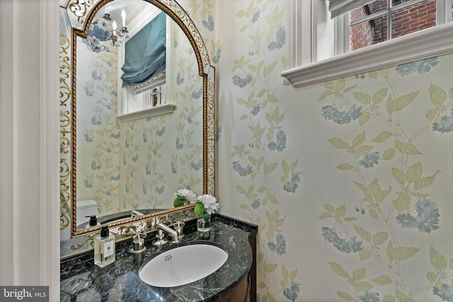 bathroom featuring a healthy amount of sunlight, vanity, toilet, and wallpapered walls