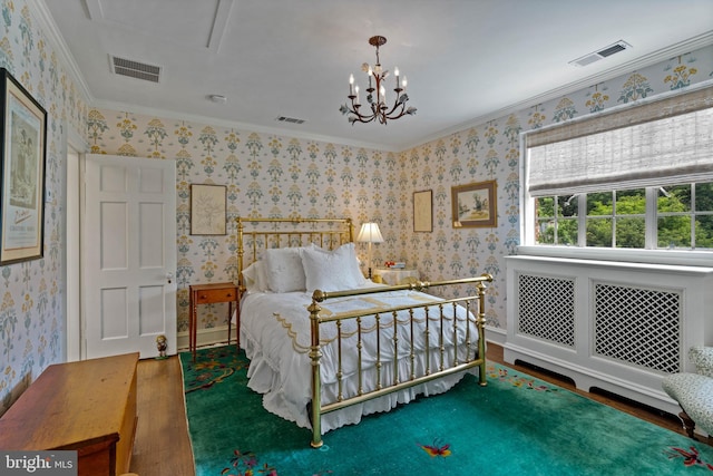 bedroom with wallpapered walls, visible vents, and wood finished floors