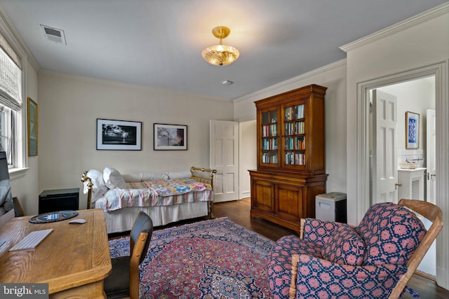 bedroom featuring crown molding, connected bathroom, visible vents, and dark wood finished floors