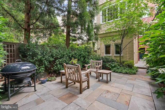 view of patio / terrace with outdoor dining area, fence, and grilling area