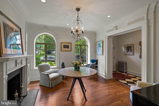 dining space featuring baseboards, radiator heating unit, dark wood-style flooring, crown molding, and a high end fireplace