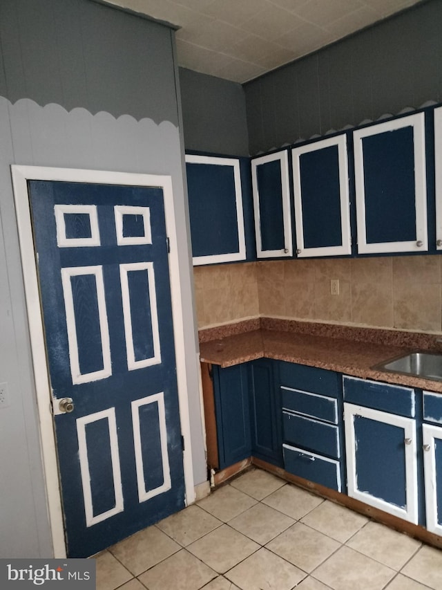 kitchen featuring light tile patterned floors and sink