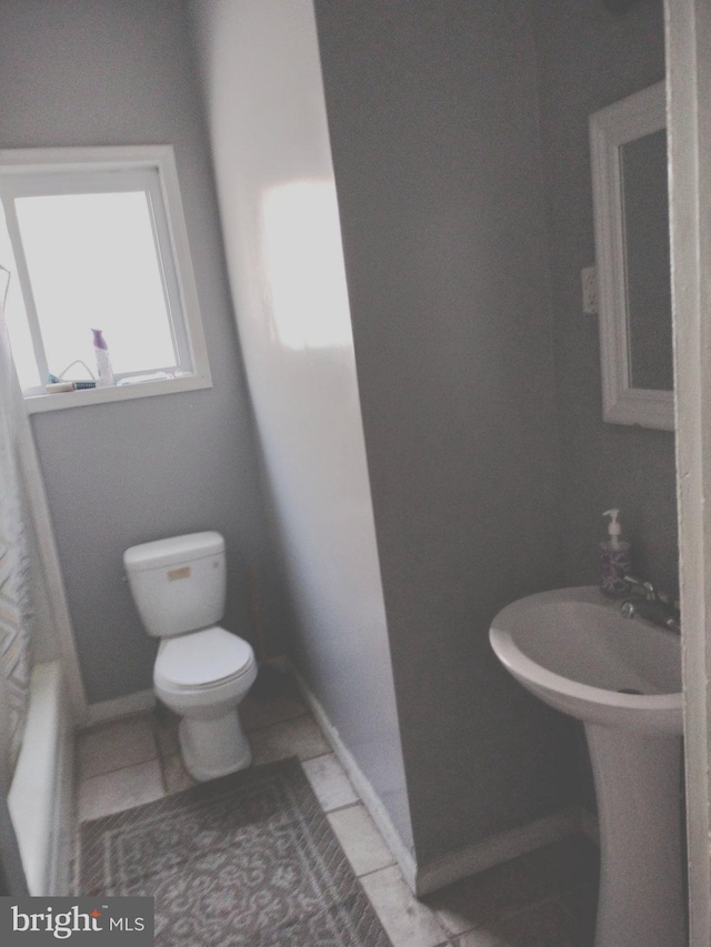 bathroom with plus walk in shower, toilet, and tile patterned floors