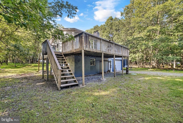 back of house with a deck and a yard