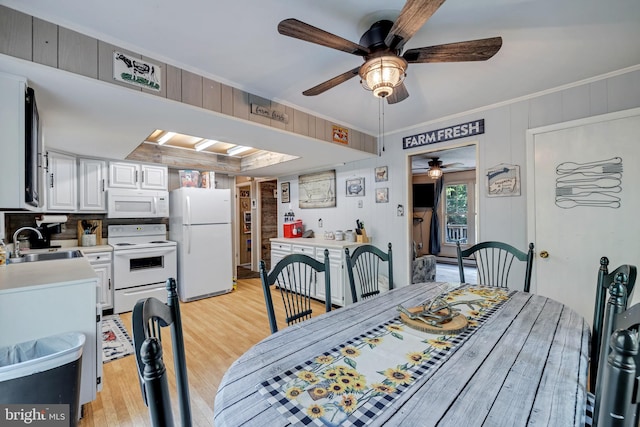 dining room with ceiling fan, sink, crown molding, and light hardwood / wood-style floors