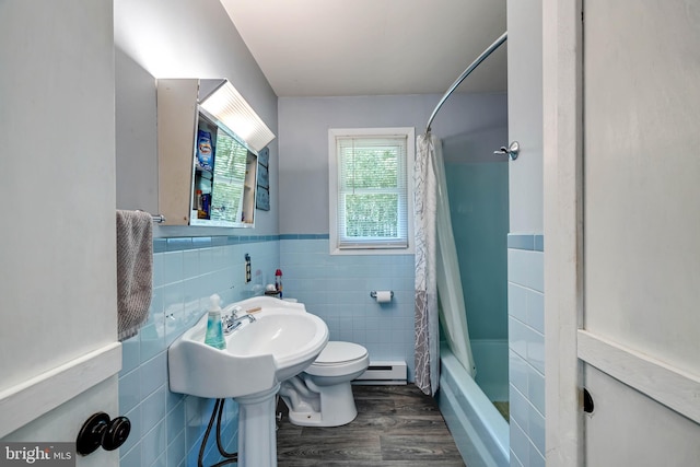 bathroom with toilet, a baseboard radiator, shower / bath combo, tile walls, and hardwood / wood-style floors