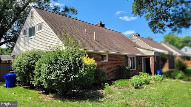 view of property exterior with a lawn