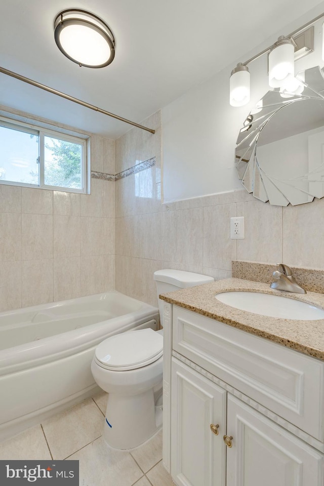 full bath featuring tile walls, bathtub / shower combination, toilet, vanity, and tile patterned flooring