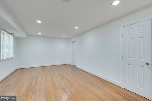 empty room featuring light wood finished floors, ornamental molding, and recessed lighting