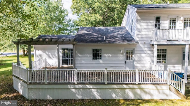 rear view of house with a deck and a balcony