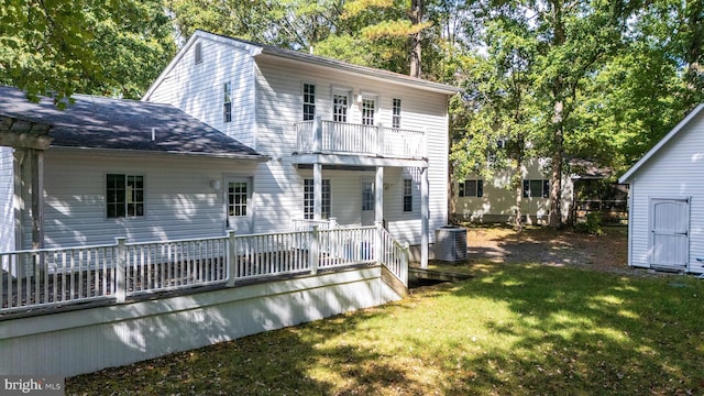 back of property with cooling unit, a yard, a balcony, and a deck