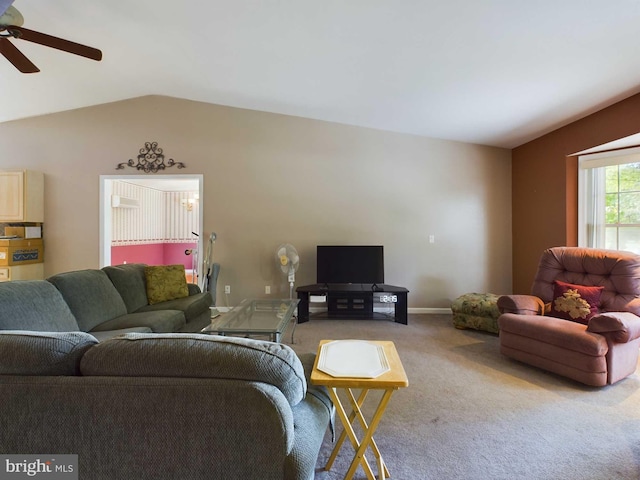 carpeted living room with ceiling fan and vaulted ceiling