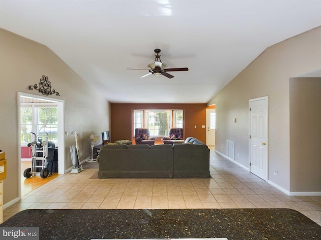 living room featuring vaulted ceiling, light tile patterned floors, and ceiling fan