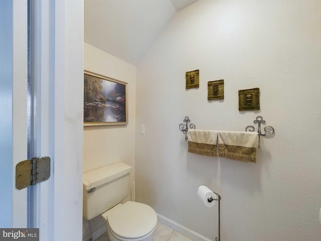 bathroom featuring lofted ceiling, toilet, and tile patterned floors