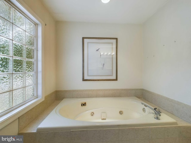 bathroom with a relaxing tiled tub