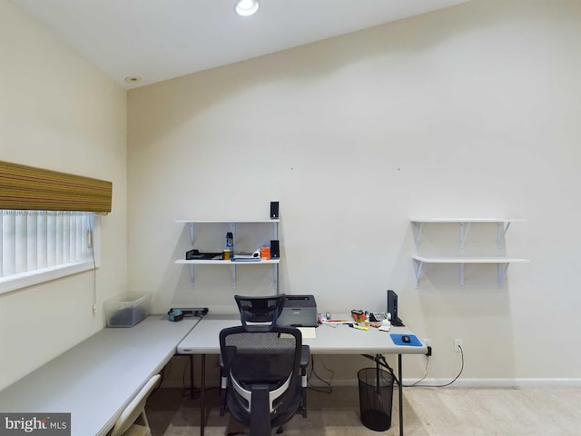 carpeted home office with lofted ceiling