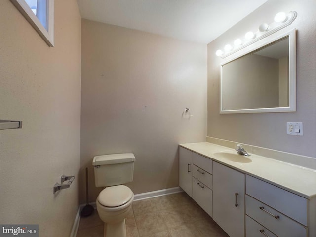 bathroom featuring tile patterned floors, vanity, and toilet