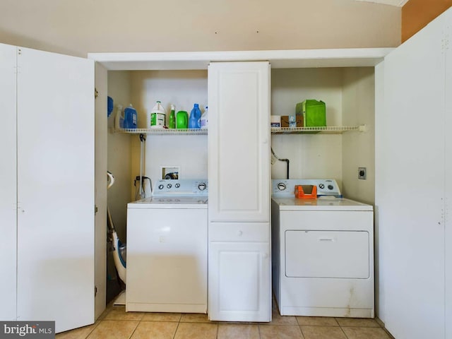 laundry area featuring light tile patterned flooring and washer and dryer