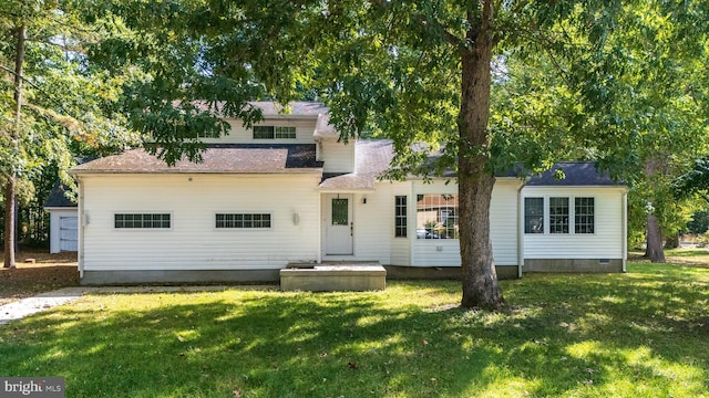 back of house with a lawn