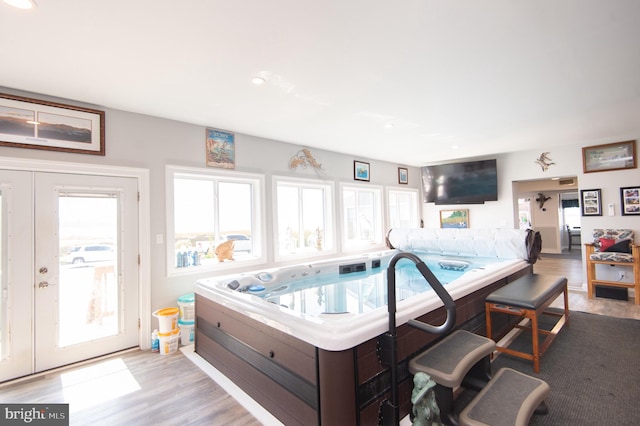 interior space with an indoor hot tub and french doors