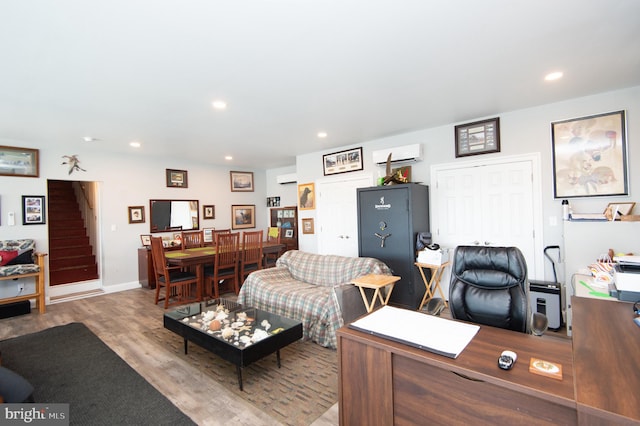 interior space featuring a wall unit AC and light hardwood / wood-style floors