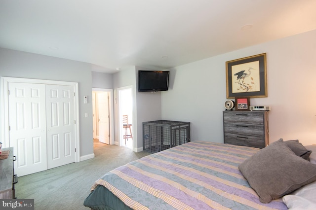 bedroom featuring light colored carpet and a closet