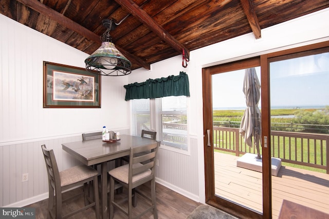 dining space with dark wood-type flooring, wood ceiling, and vaulted ceiling with beams