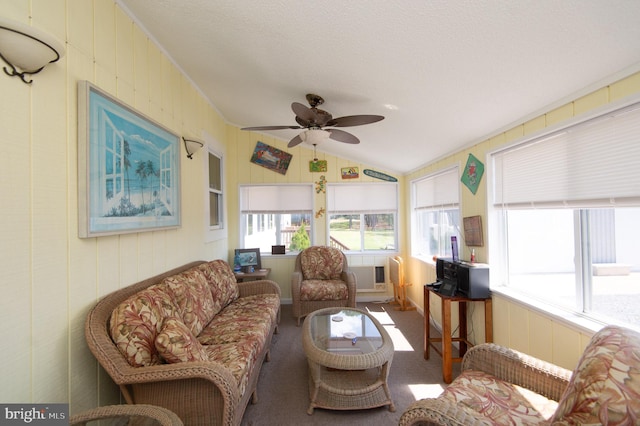 sunroom with ceiling fan and vaulted ceiling