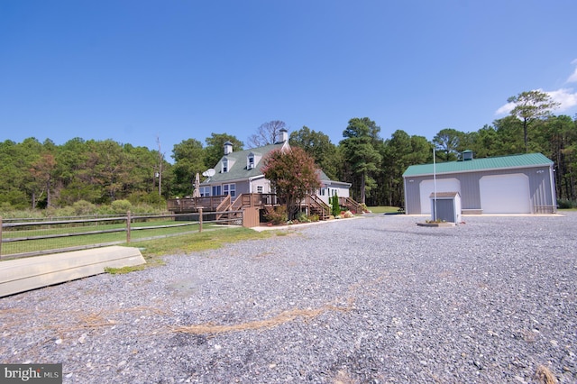 view of front facade with an outbuilding and a garage