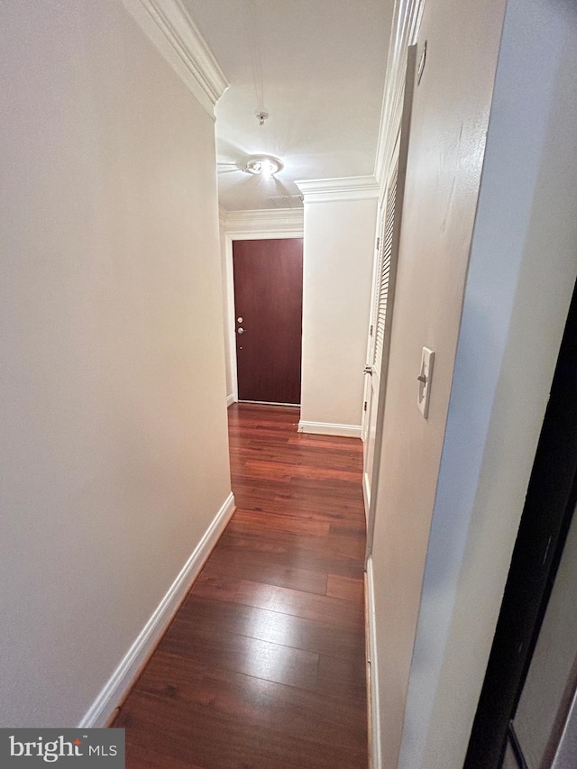 hall with crown molding and dark wood-type flooring